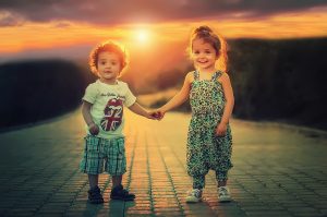 image of two children holding hands