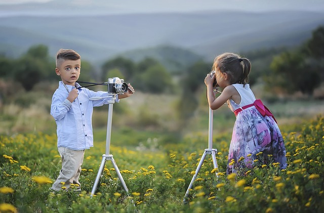image of two children pretending to be photographers