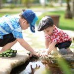 image of two children playing with water