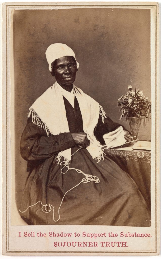 old black and white portrait of a old black woman in a sitting postion