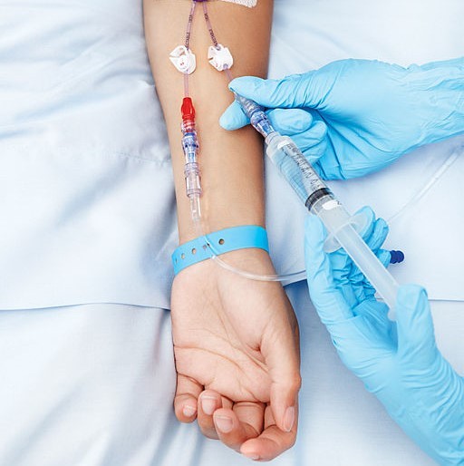 Image showing the delivery of drug by IV into arm.