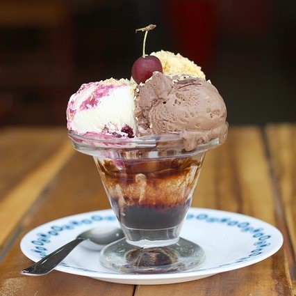 Photo of an ice cream sundae with a cherry on top