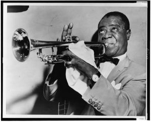 Louis Armstrong, head-and-shoulders portrait, facing left, playing trumpet
