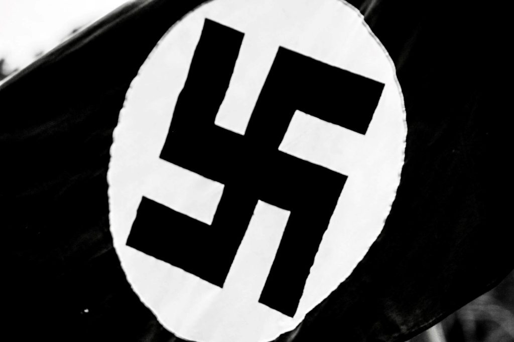 Black flag with a swastika in a white circle in the center