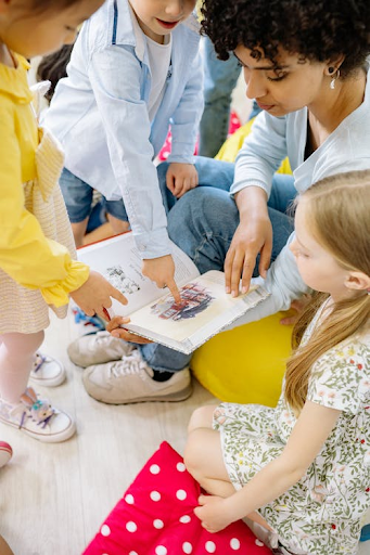 Educators use informal assessment practices to provide in the moment guidance for young children. Seen in this photo is a child responding to an illustration in a book.