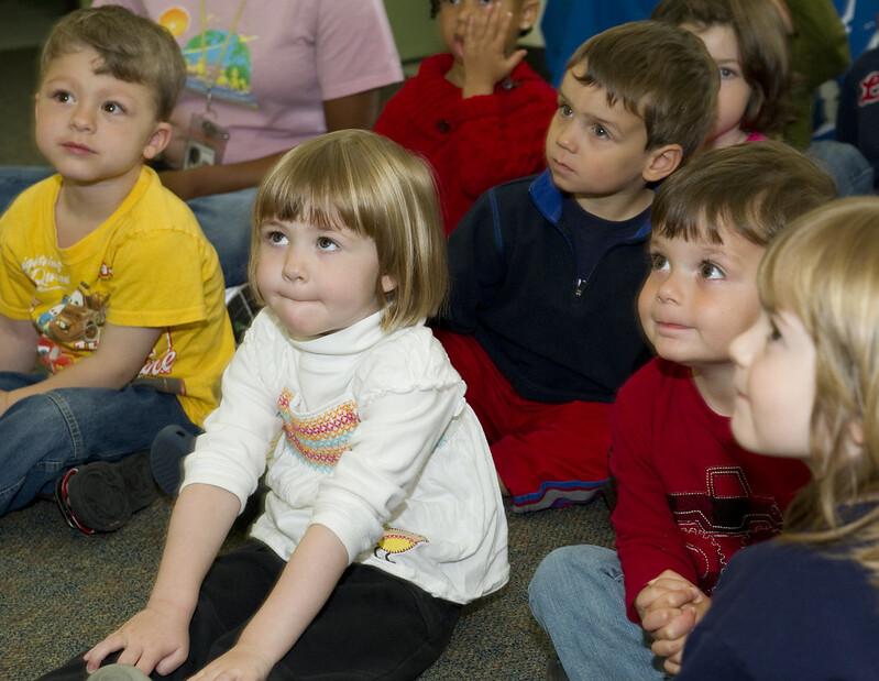 Children have more receptive language than expressive language as seen by these children listening attentively