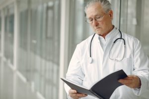 image of white male doctor looking at chart