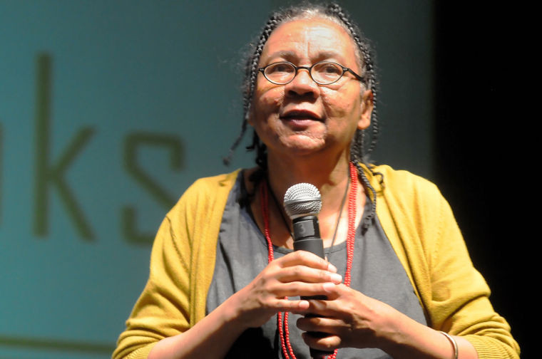 Photo of bell hooks holding a microphone