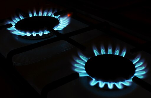 A blue flame on a two-burner gas stove