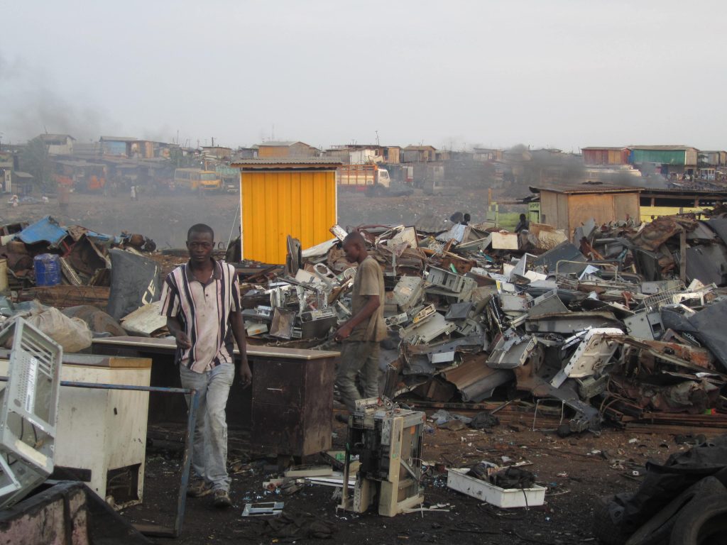 Ghanaians working in Agbogbloshie, a suburb of Accra, Ghana....Low-income workers in Ghana recycling waste from high-income countries, with recycling conditions heavily polluting the Agbogbloshie area.