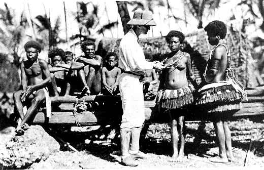 Black and white photo of Bronislaw Malinowski (center) with Trobriand Islanders circa in 1918