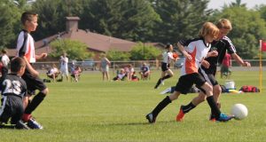 image of children playing soccer