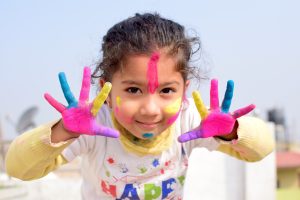 image of chid with painted hands and face