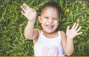 image of a smiling girl in the grass