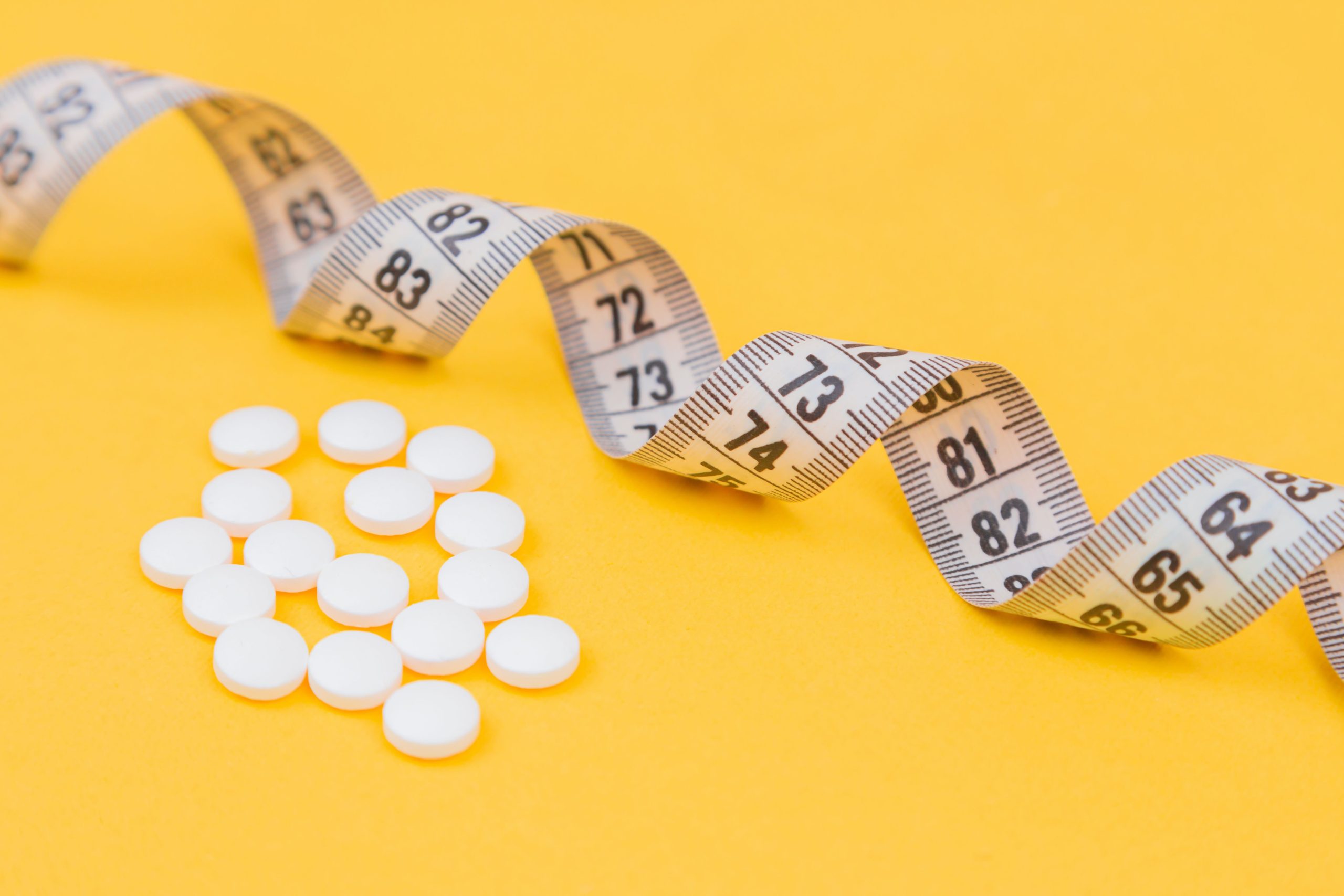 image of measuring tape and pills