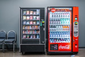 image of 2 vending machines 1) candy and snacks 2) soda and water